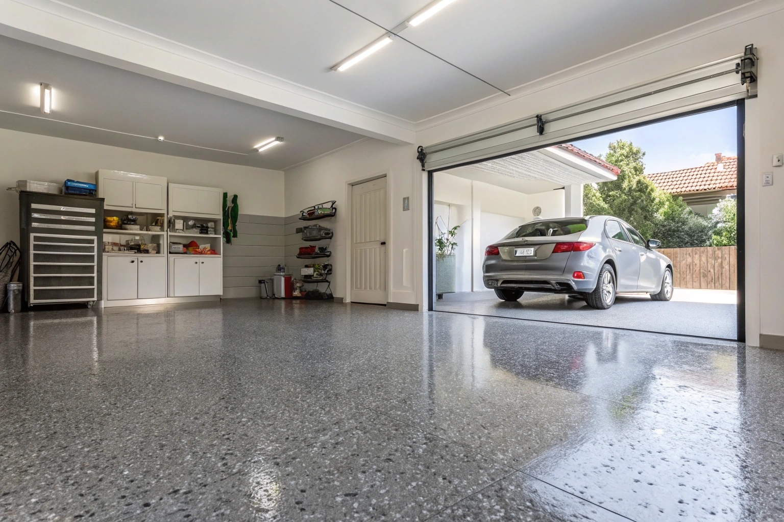 Modern grey epoxy garage floor coating with decorative flakes in Barrack Heights residential home